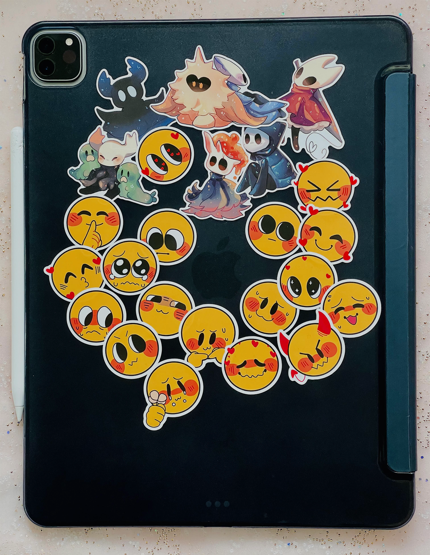 The back of an iPad, covered in various sticker designs.