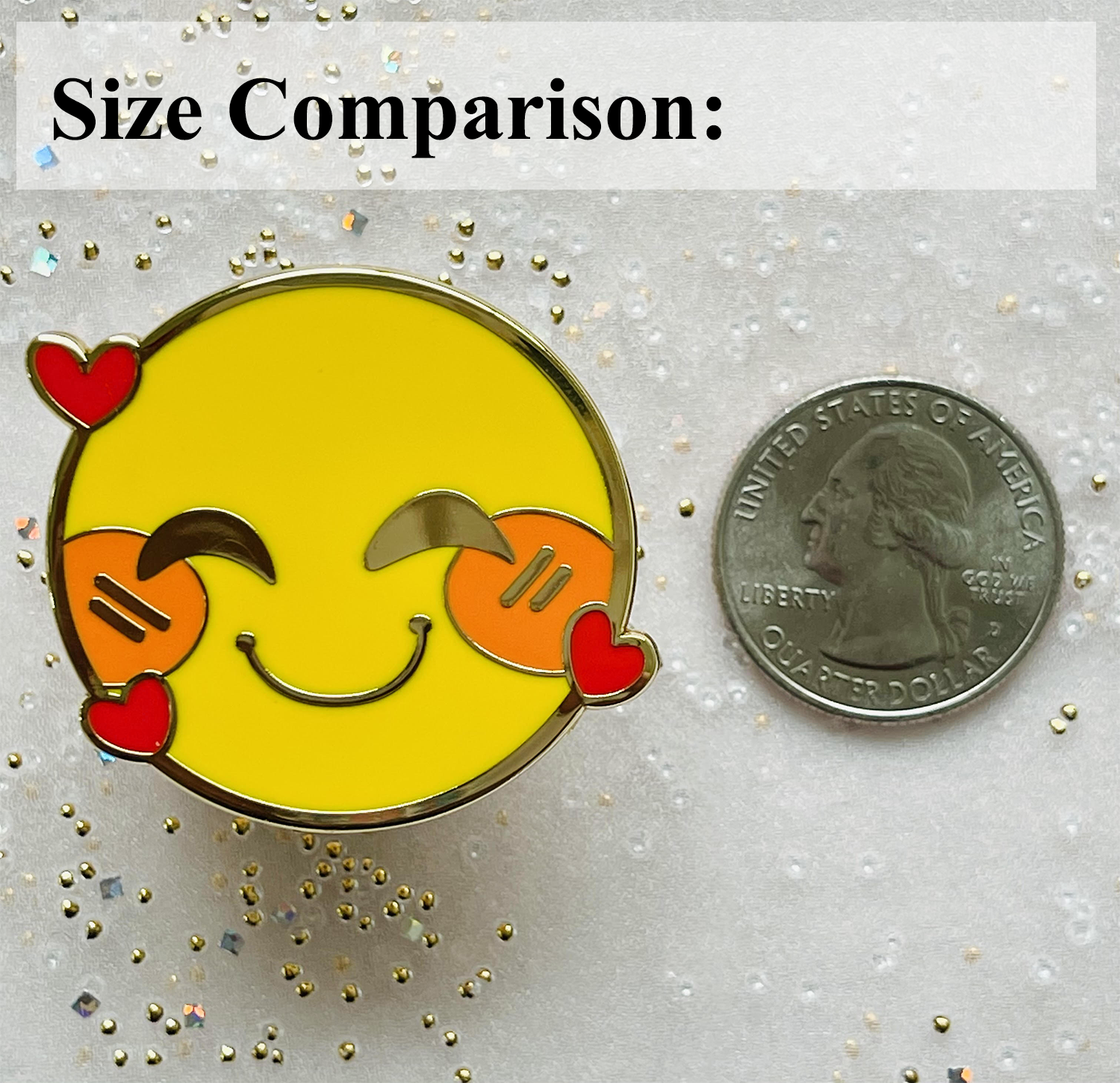 An enamel pin shown next to a quarter as a size comparison. It is 1.5 times the size of the quarter.