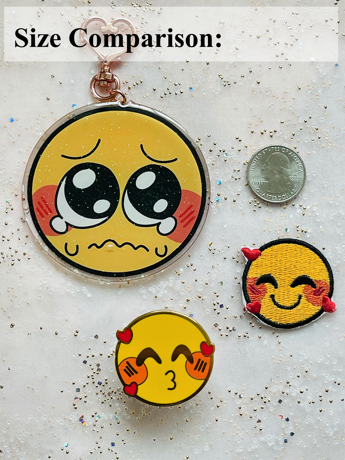 An acrylic charm, pin, and patch shown next to a quarter as a size comparison. The pin and patch are the same size, and are 1.5 times the size of the quarter. The acrylic charm is double the size of the pin and patch, and three times the size of the quarter.