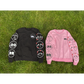 Two nice emoji sweaters side by side. The sweater on the left is black, and the sweater on the right is pink. Both feature various emoji designs on the front and sleeves.